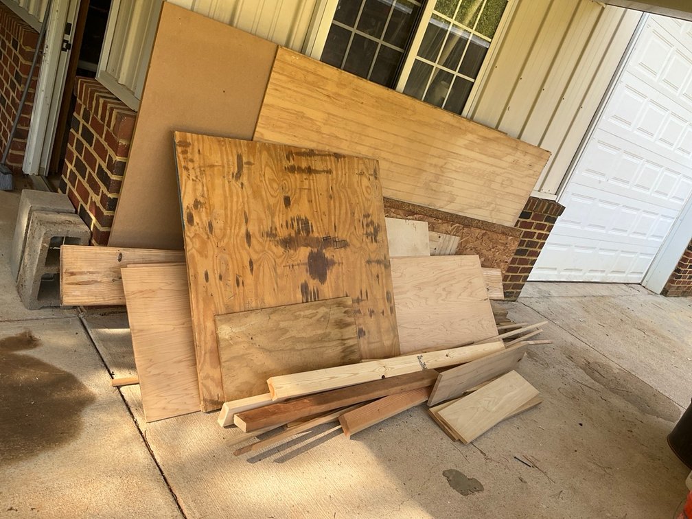 Assorted Plywood Sheets and Dimensional Lumber Building Materials