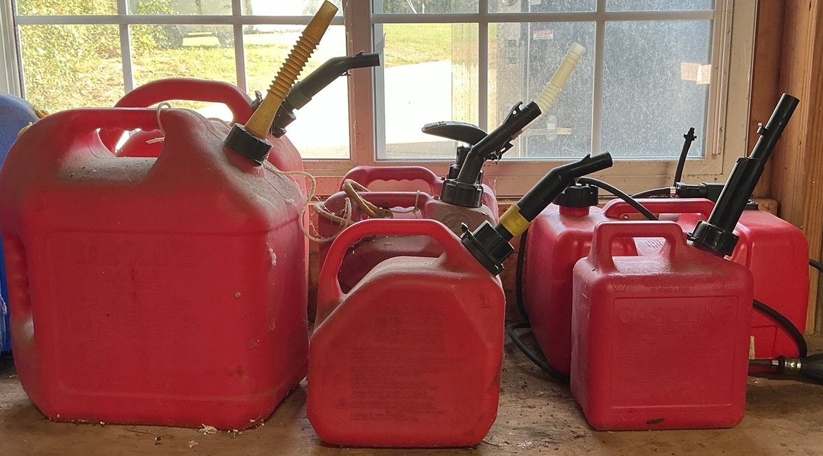 Assorted Red Plastic Fuel Cans and Portable Marine Boat Gas Tank