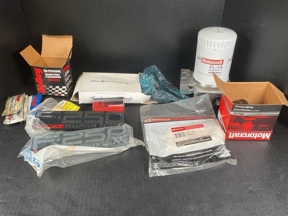 Assorted Ford Truck Emblems And Maintenance Parts