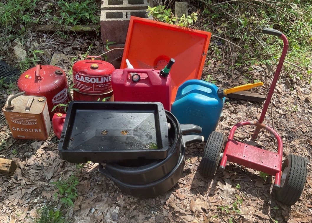 Assortment Of Fuel Cans And Fluid Drain Pans