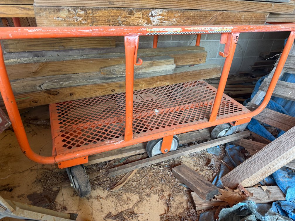 Rolling cart and lumber stacked on top