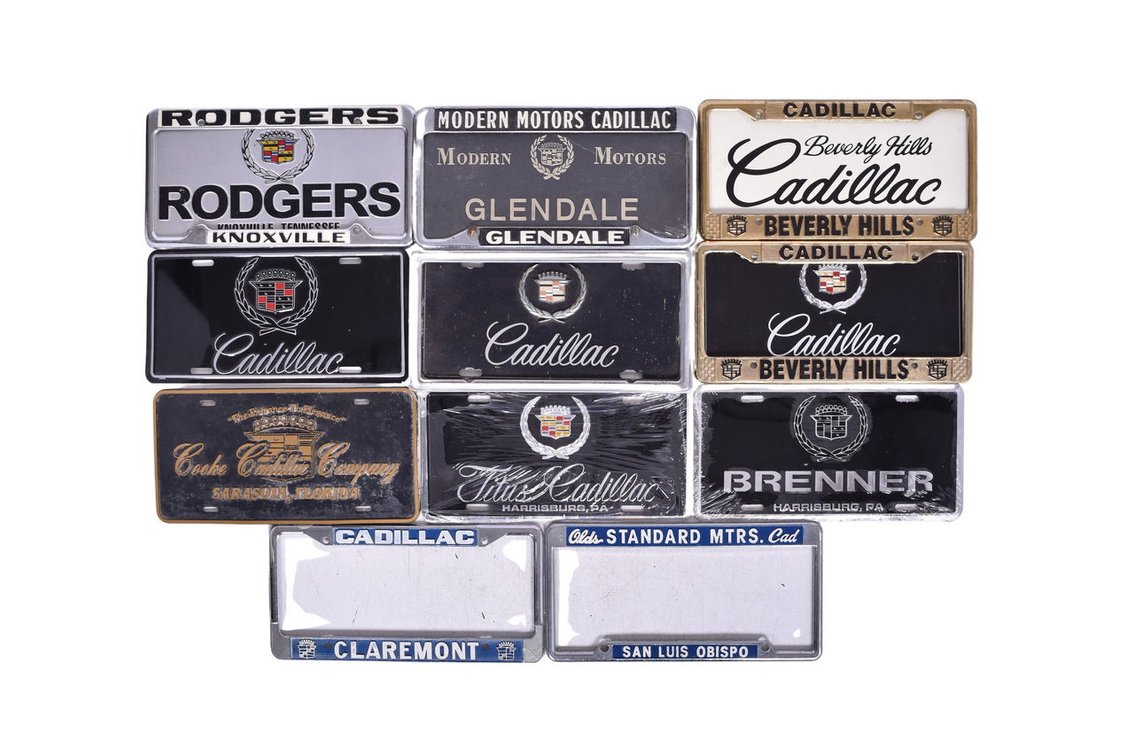 Seven Cadillac Car Dealership Advertising Metal License Plate Frames and Nine Inserts