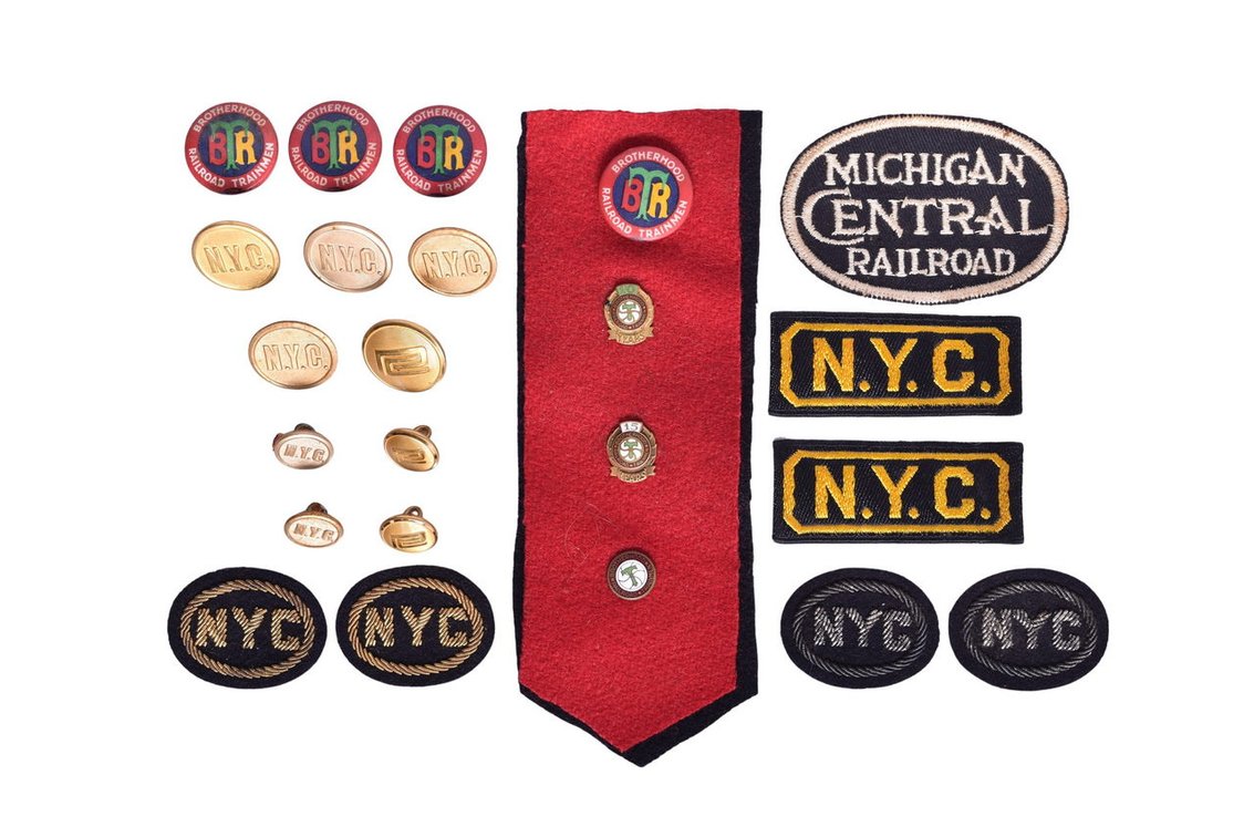 Railroad Ephemera Group Of Twenty-Four Items- New York Central Buttons, Penn Central Buttons, Brotherhood Of Railroad Trainmen Service Pins, N.Y.C. Patches
