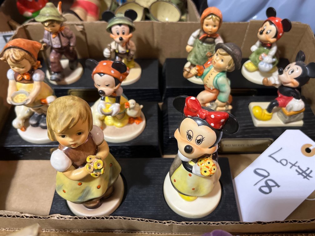 Goebel Mickey and Minnie Mouse figurines on wood bases.