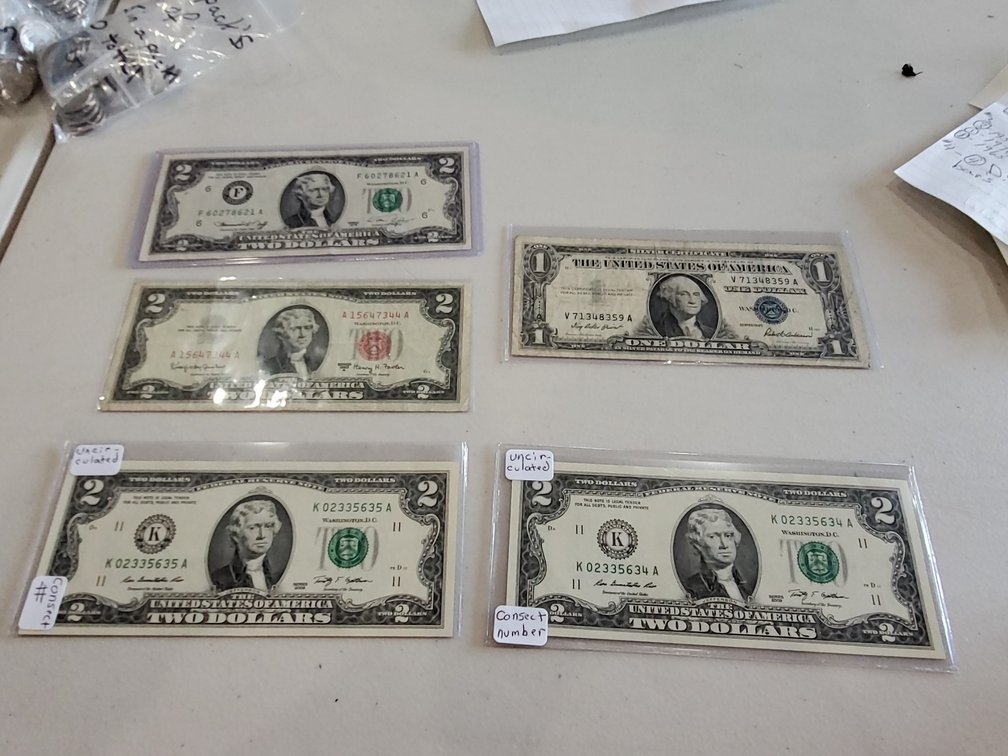 Dollar and $2 bills- information below