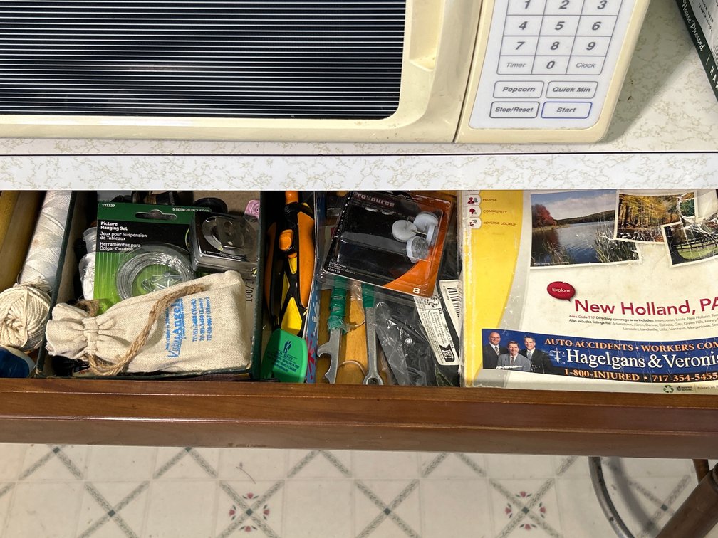 Drawer Contents- Tools, Picture Hanging Wire, Phone Book, Towels, Tape, Cookbooks, Etc.