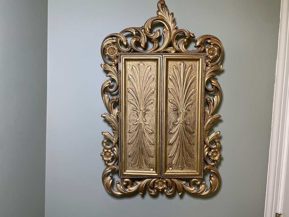 Gold Tone Wall Cabinet with Scrollwork Frame, Houses Jewelry Box & Mirror