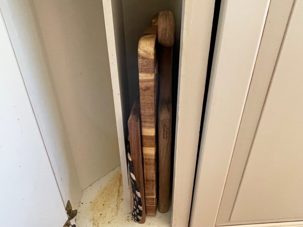 Contents of Cabinet- Wooden Cutting Boards, Braided Trivet Mat
