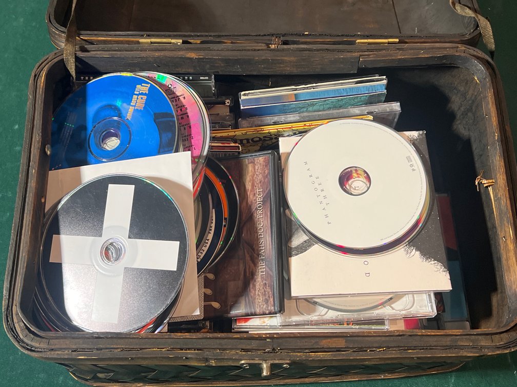 Assortment of Loose Musical CDs in Woven Wicker Basket with Hinged Lid