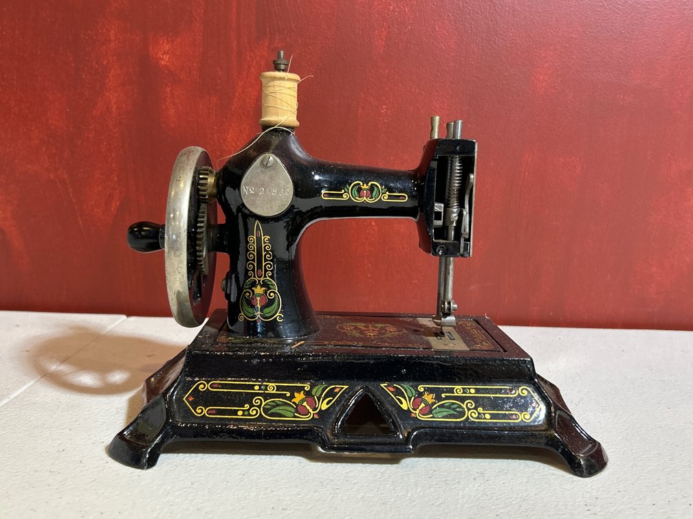 Antique German child's miniature hand-crank sewing machine