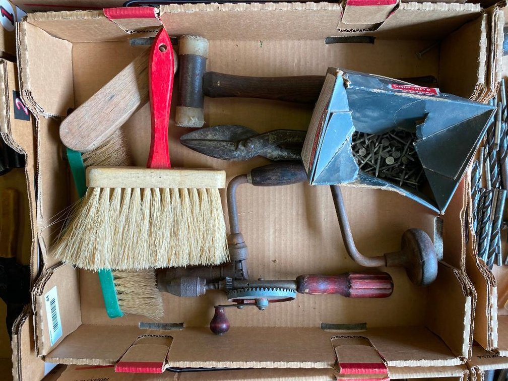 box of brushes, hand drill, hammer and nails