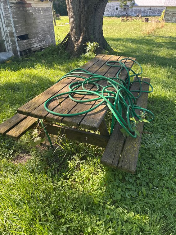 Wooden Picnic Table and Garden Hose