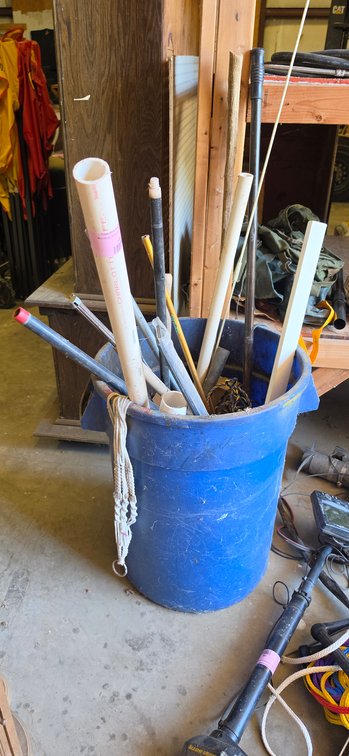 Blue Plastic Barrel with PVC Pipe, Metal Conduit, and Poles