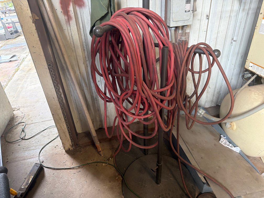 Red Air Hose on Freestanding Metal Stand