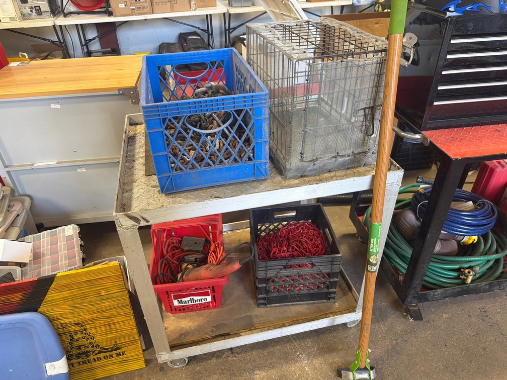 Two-Tier Rolling Cart with Tools, Chains, and Wire Cage