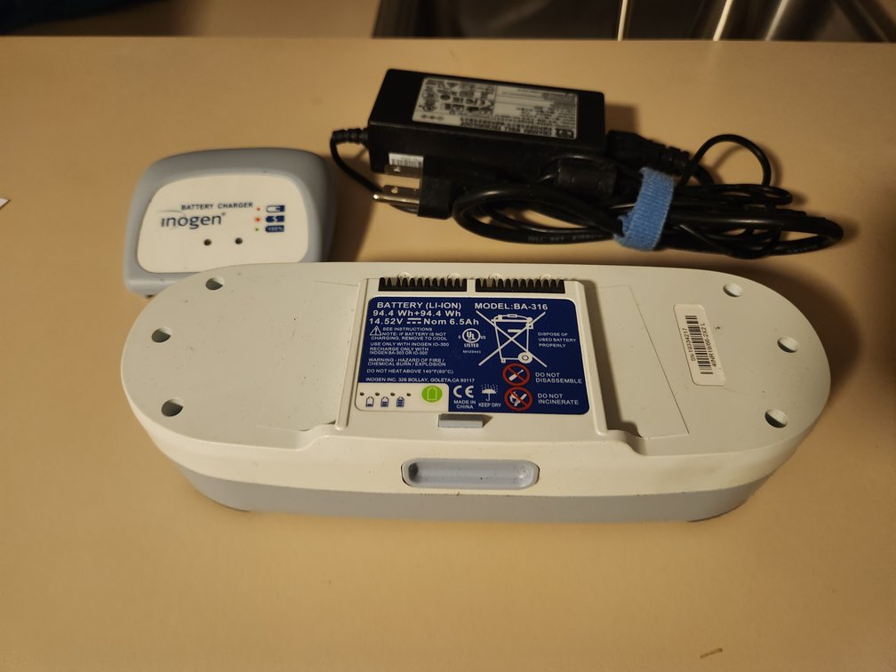 Inogen One O2 concentrator double life battery with charger and cord.