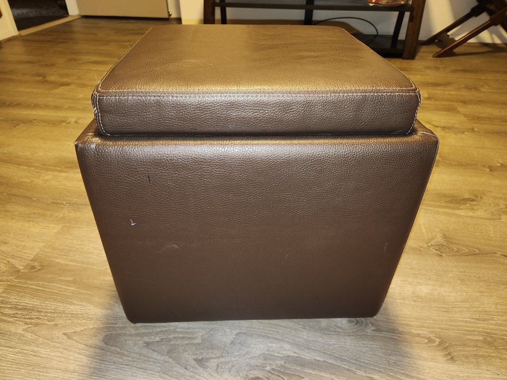 Rolling brown leather storage ottoman 