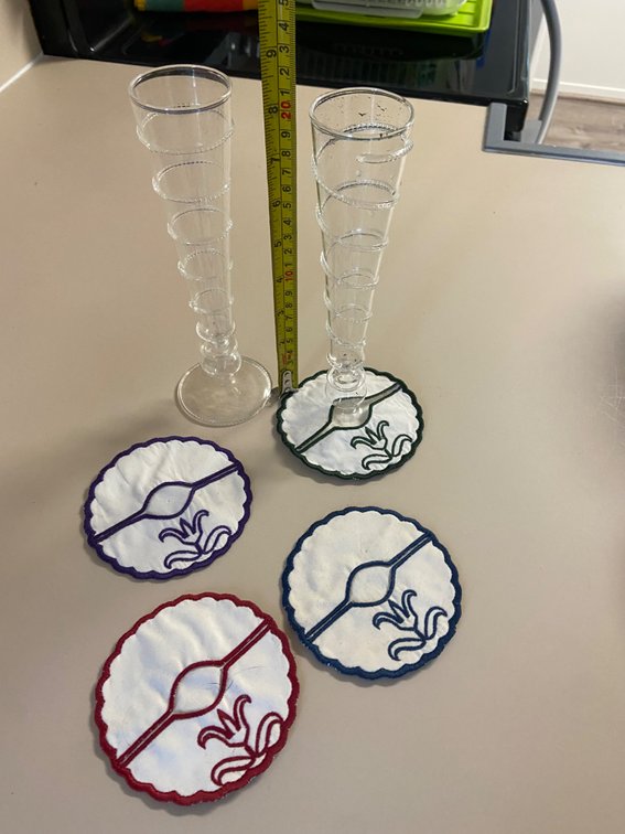Two tall fancy champagne flutes, and four ID coasters