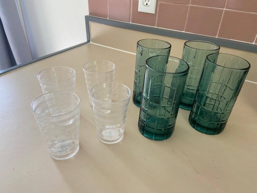 Two sets of glasses, tall, turquoise glass, and short plastic