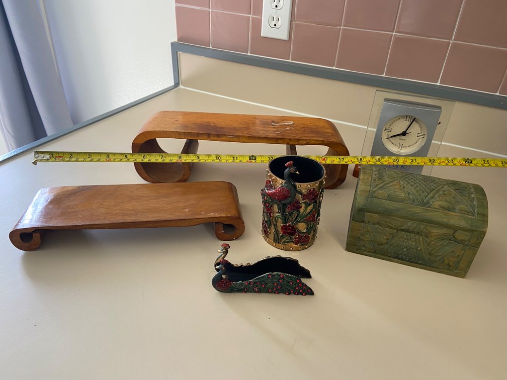 Assortment of decorative display items, box, carved wooden platforms, Clock, pen and letter holders