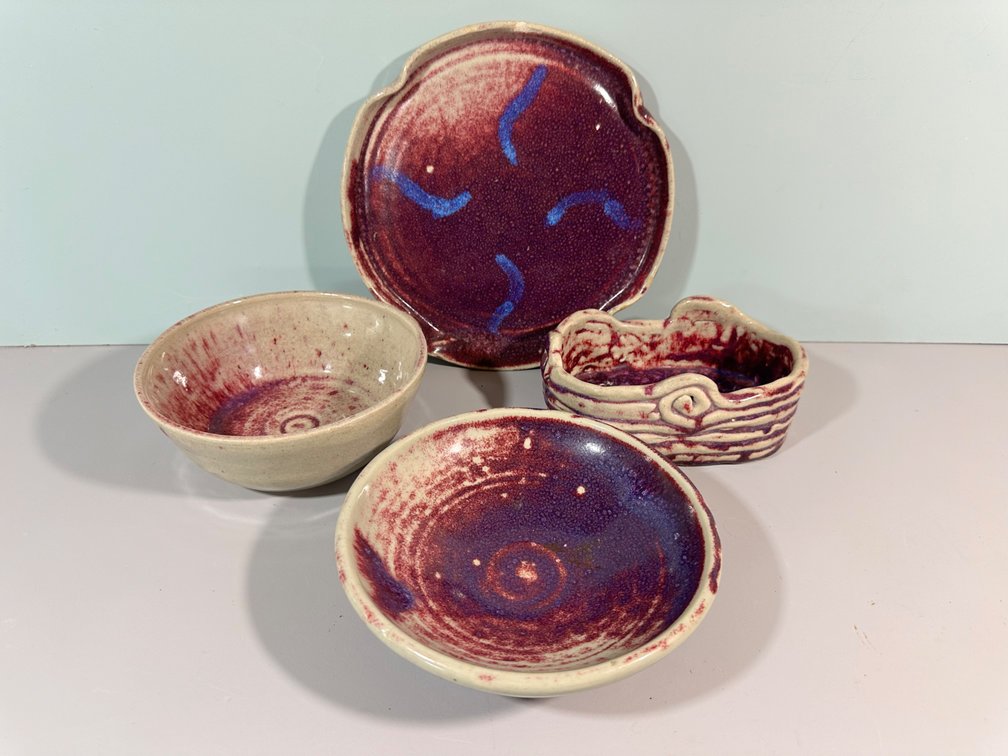 Collection of Handcrafted Red and Purple Ceramic Dishware