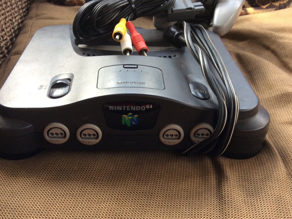 Nintendo 64 with cords and a controller 