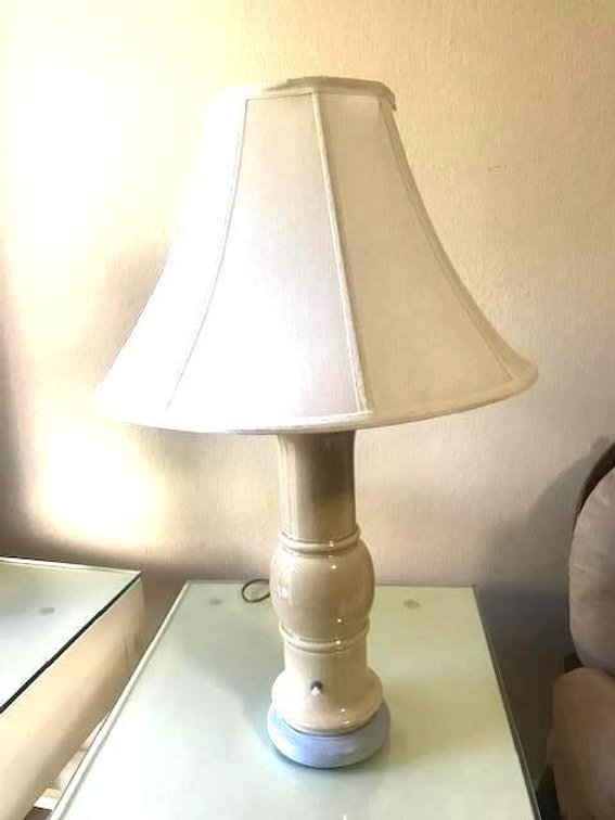 Ceramic Lamp with white fabric shade. Adjustable light control  Lamp 28" tall.