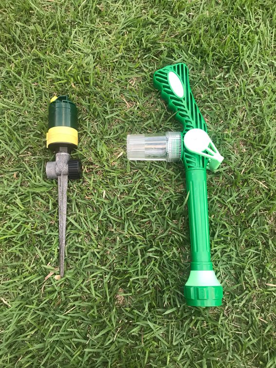 single sprinkler and water hose garden sprayed