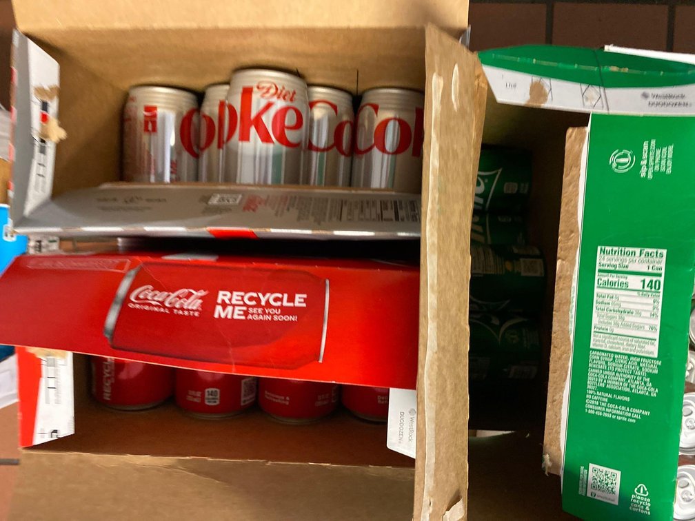 Open Cases of Cans of Coke, Diet Coke and Sprite