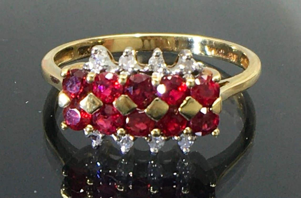 10 Karat Fine Gold Estate Ring with Eight Diamonds and 10 Bright Rubies.  Size 8