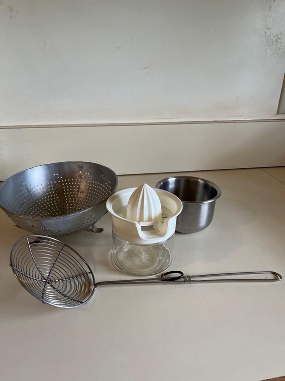 juicer, colander, stainless steel bowl and stainless steel ladle strainer