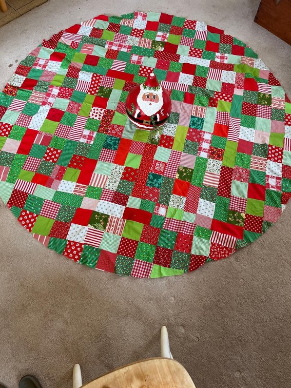 Hand acrylic painted Santa gourd and handmade Christmas quilt.
