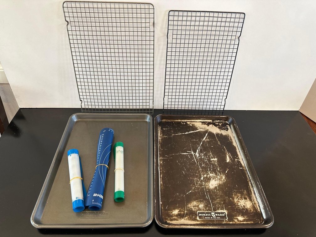 Mixed Lot of Baking Sheet Pans, Cooling Racks, and Reusable Nonstick Cookie Sheets