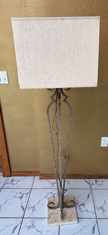 Tall Floor Lamp Featuring Metal Legs and a Stone Base