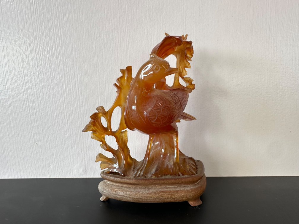 Intricately Carved Bird Figurine on Wood Base