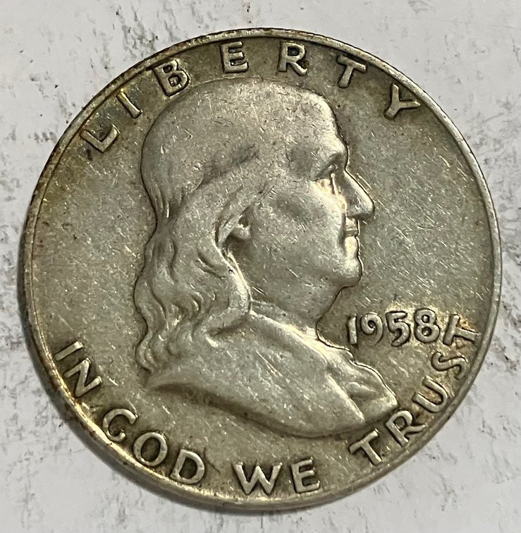 1958 D. Benjamin Franklin half dollar.  Nice coin. Lettering is all in good order markings are simply tarnish.