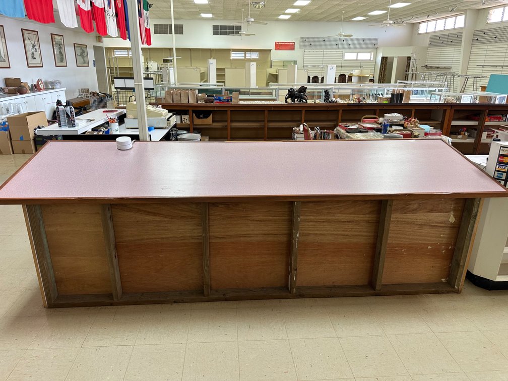 Retail Counter with Angled Countertop and Storage Shelving