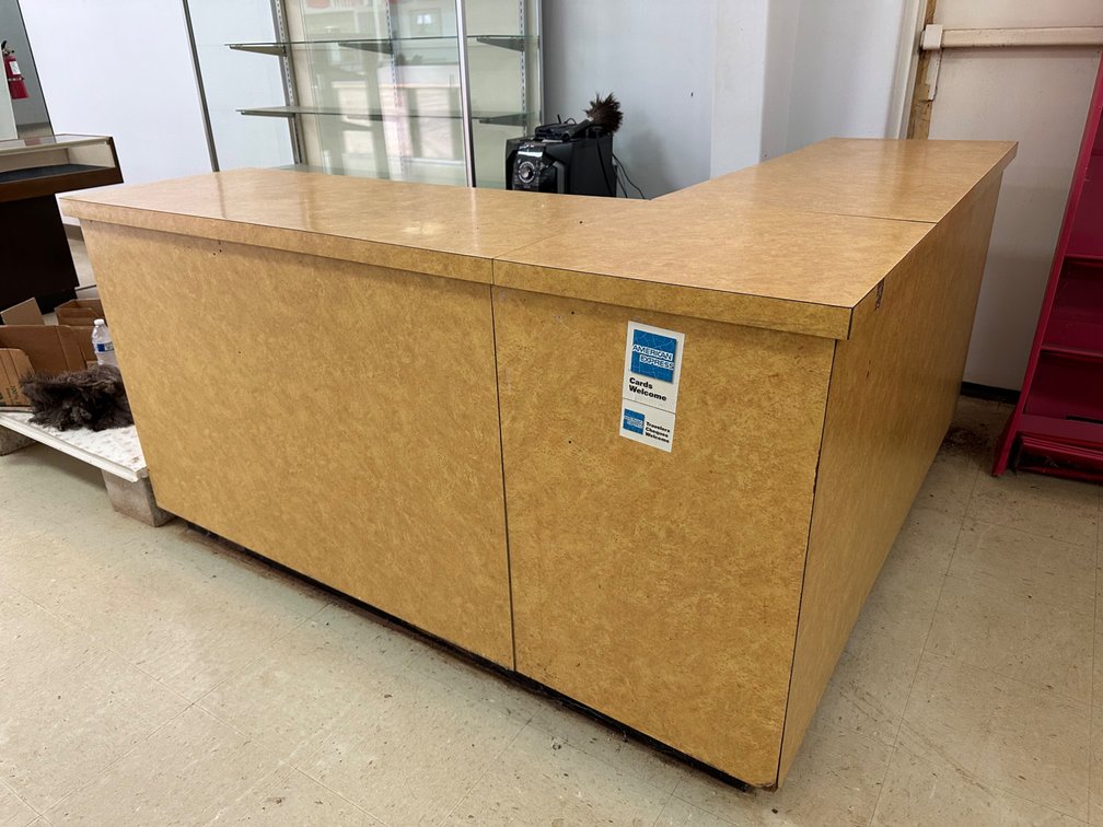 L-Shaped Retail Counter with Storage Shelves