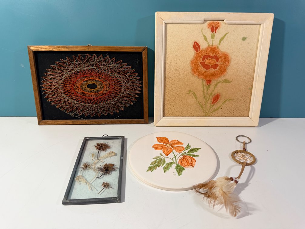 Mixed Decorative Art Lot Including String Art, Floral Wall Art, Tile Trivet, Pressed Flower Frame, and Woven Keychain