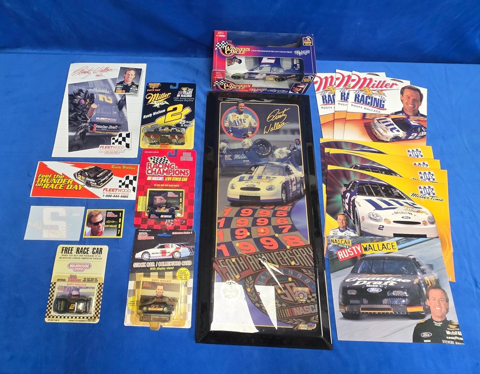  (4) 1/64 Scale, (1) 1/24 Scale Rusty Wallace Die Cast Cars, Clock, And More.