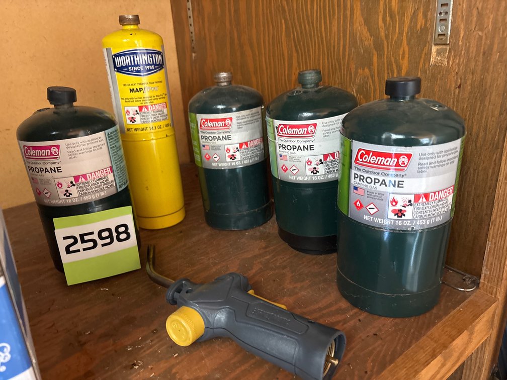 Map and propane, gas canisters, torch