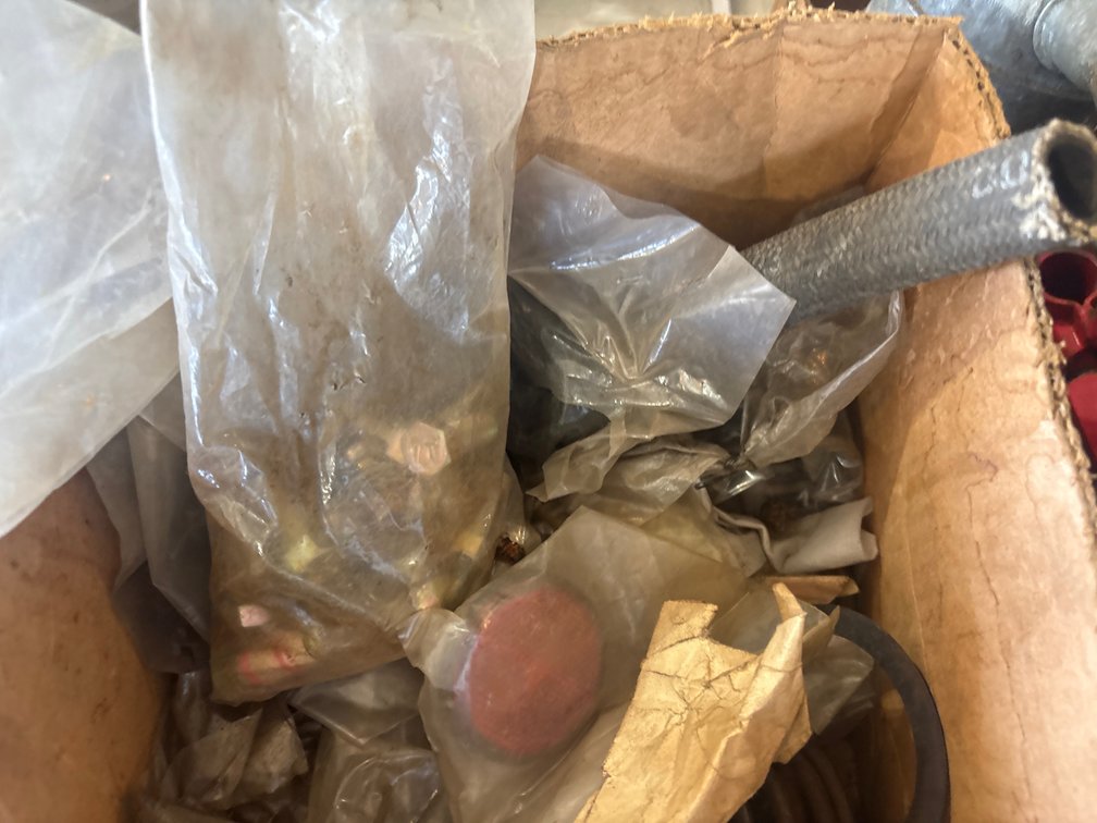 Box of bolts and parts with Allis Chalmers paper tags
