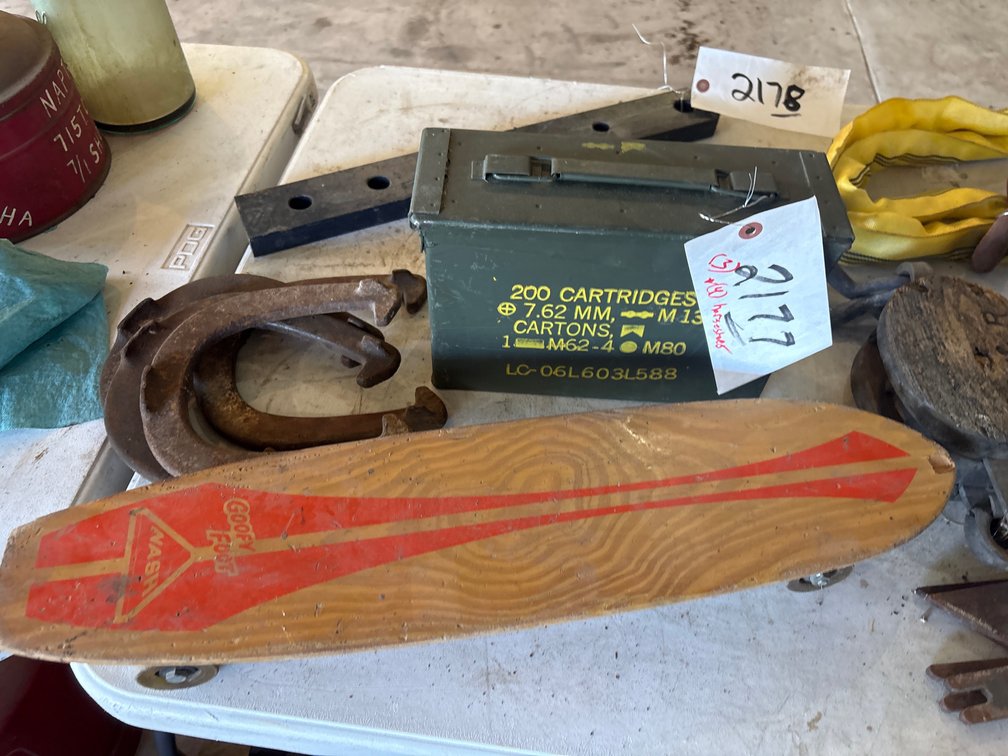 (4) horse shoes, ammo case, skateboard, wooden pulley