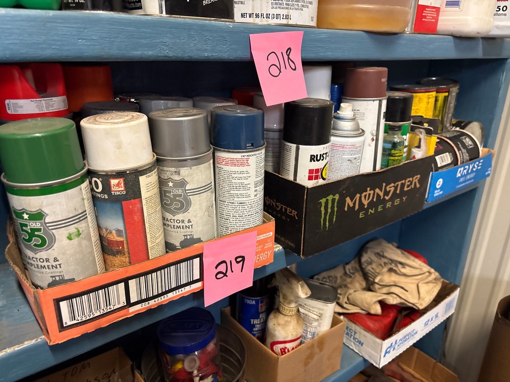 Partial cans of spray paint, stain and wheel bearing grease