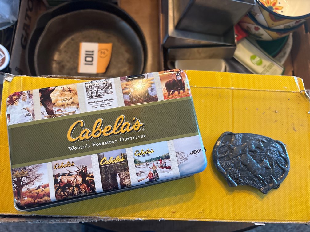 Cabelas tin and 1977 deer belt buckle