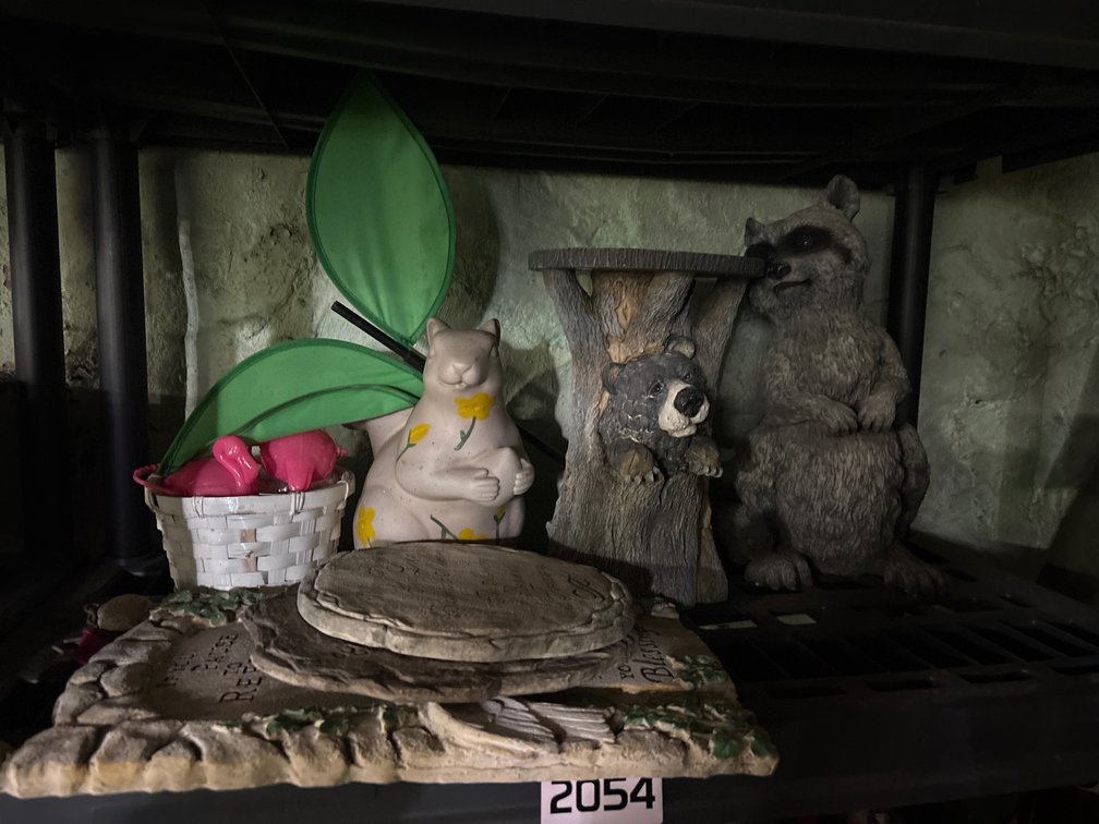 Shelf of outdoor figures and plaques