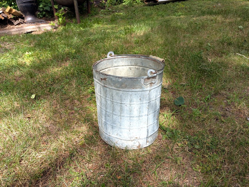 Cute old bucket with original wooden handle measures 13" tall.