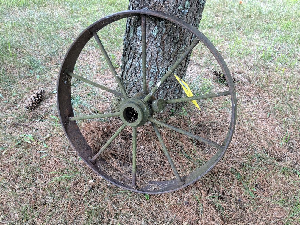Old steel wheel measures approx 23" wide.