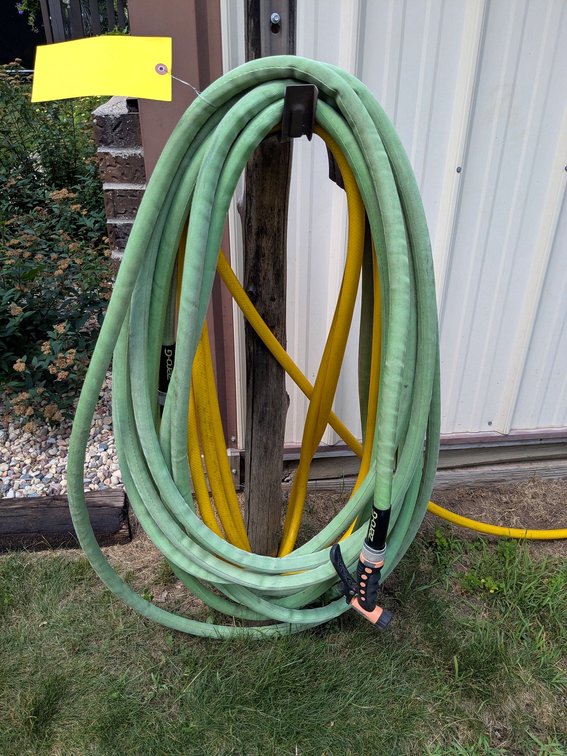 Two coils of garden hose, are each approx 3-1/2" tall. One is a Zero-G and other.