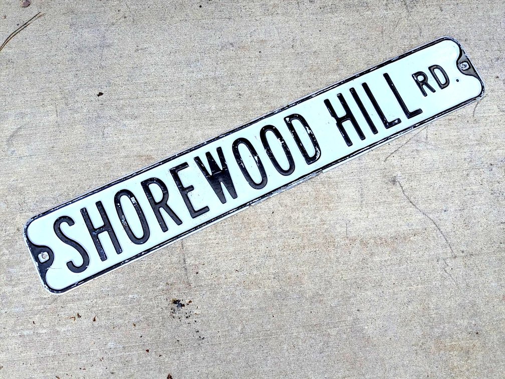 Embossed Shorewood Hill Rd metal sign is 3' long.